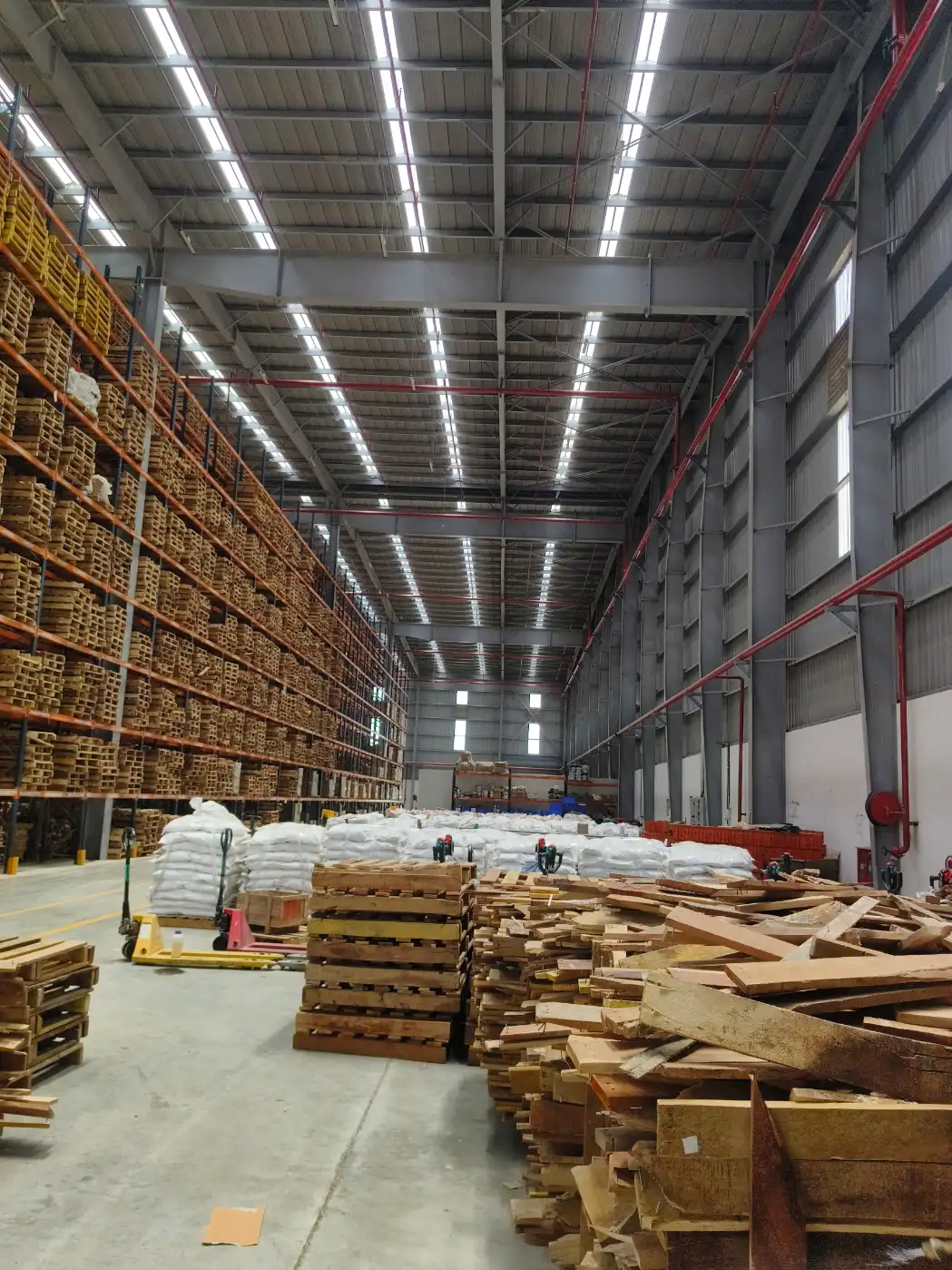 Commercial Amc Ipm service context: Palletized goods stored inside a commercial warehouse facility.