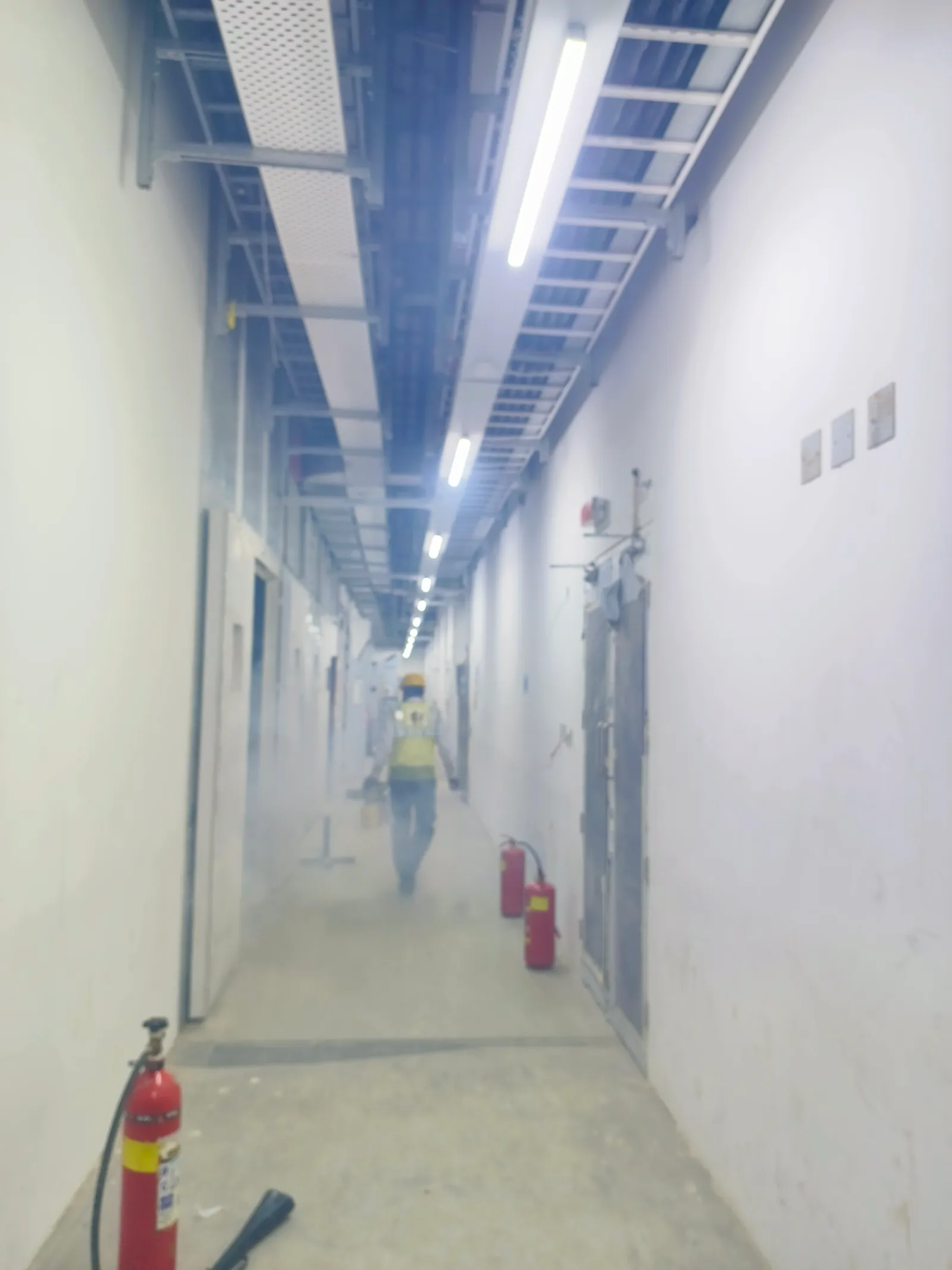 Pest Control For Hospitals Clinics service context: Thermal fogging applied through an indoor building corridor.